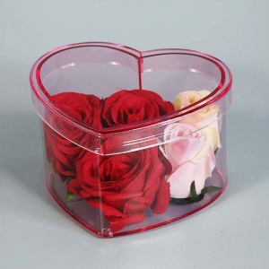 caja de flores de plexiglás en forma de corazón de color rosa 